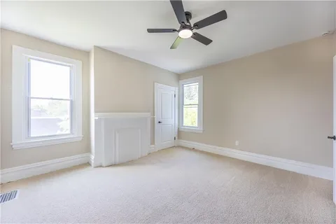 a view of a livingroom with a ceiling fan & a ceiling fan