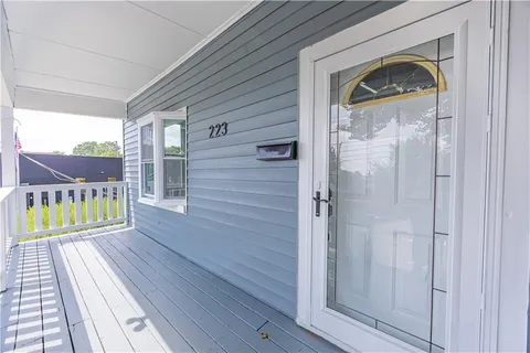 a view of front door deck and a yard