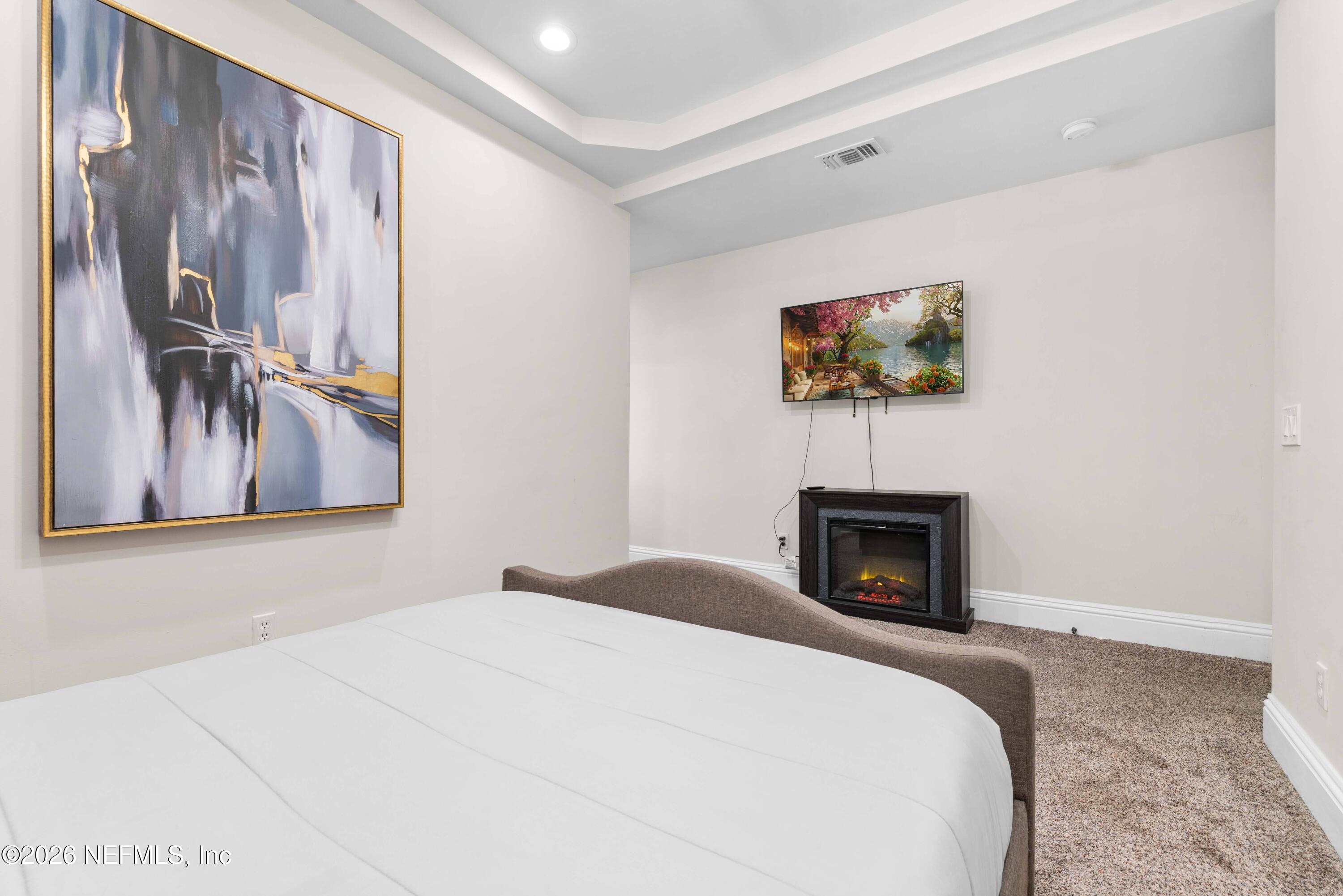 1138 Walnut Street Jacksonville, FL 32206 - Photo 12 of 37 a bedroom with a bed and a fireplace
