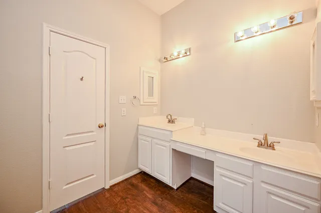 a bathroom with a double vanity sink a mirror and a shower