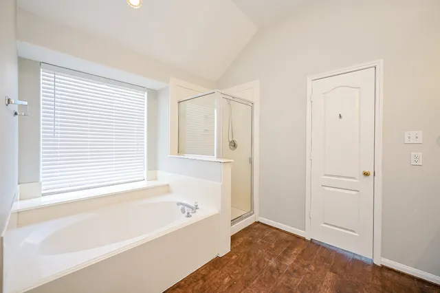 a bathroom with a bathtub and a shower