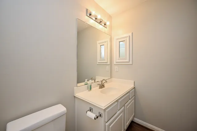 a bathroom with a sink a toilet and vanity