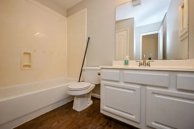a bathroom with a sink a toilet and a bathtub