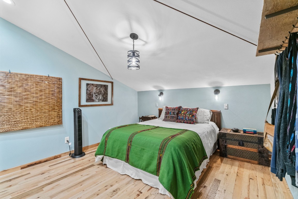 7394 Creek Road Dripping Springs, TX 78620 - Photo 18 of 39 a bedroom with double bed and a window