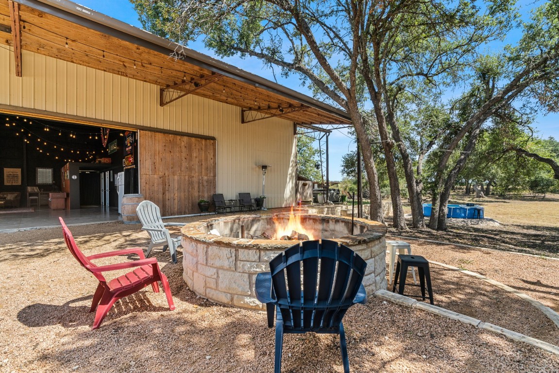 7394 Creek Road Dripping Springs, TX 78620 - Photo 21 of 39 a outdoor space with patio lots of furniture and flowers