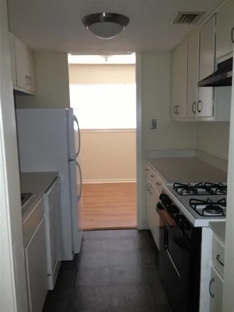 a kitchen with a stove and a refrigerator