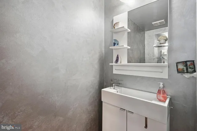 a room with furniture a flat screen tv and kitchen view