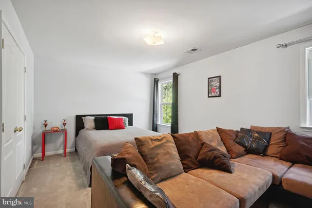 a room with furniture a flat screen tv and kitchen view