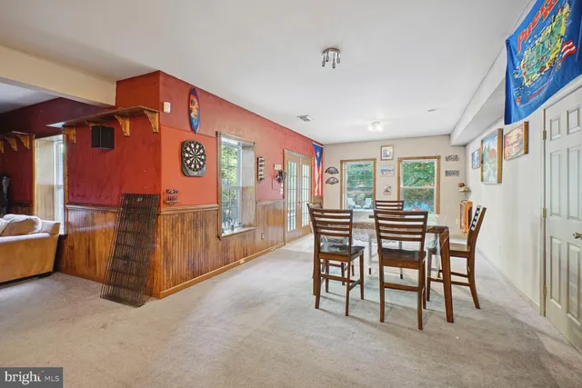 a view of a roof deck with table and chairs and wooden floor