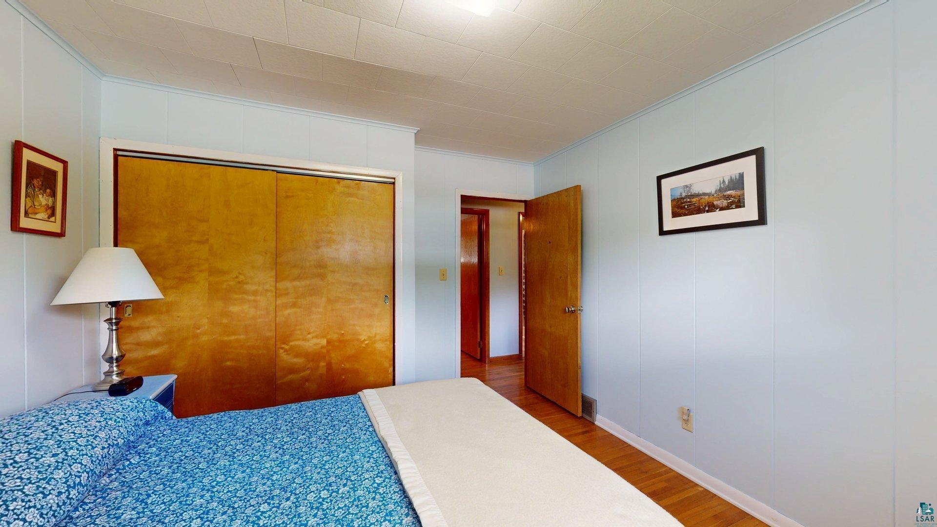 10614 Moose Lake Road Orr, MN 55771 - Photo 28 of 44 Light blue paneled walls frame the interior, featuring wood-finish flooring
