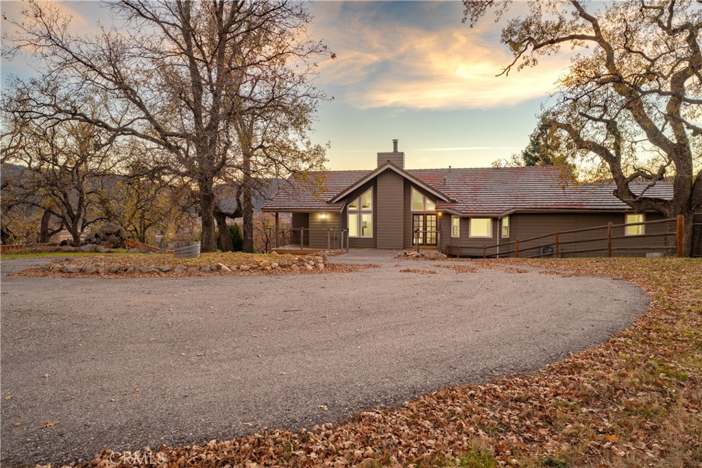 24500 Deertrail Drive Tehachapi, CA 93561 - Photo 1 of 1 a front view of a house with a yard and garage