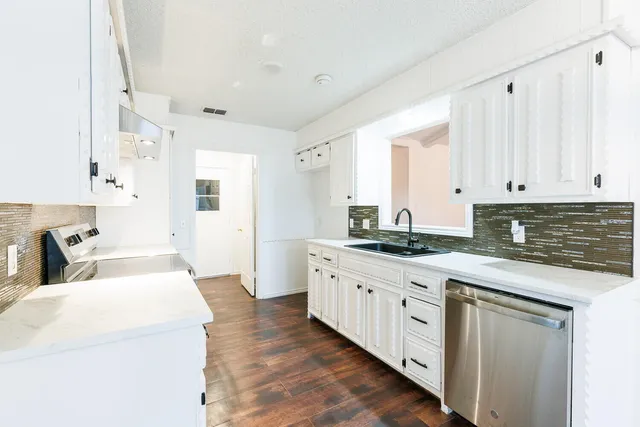 a kitchen with a sink and a stove top oven