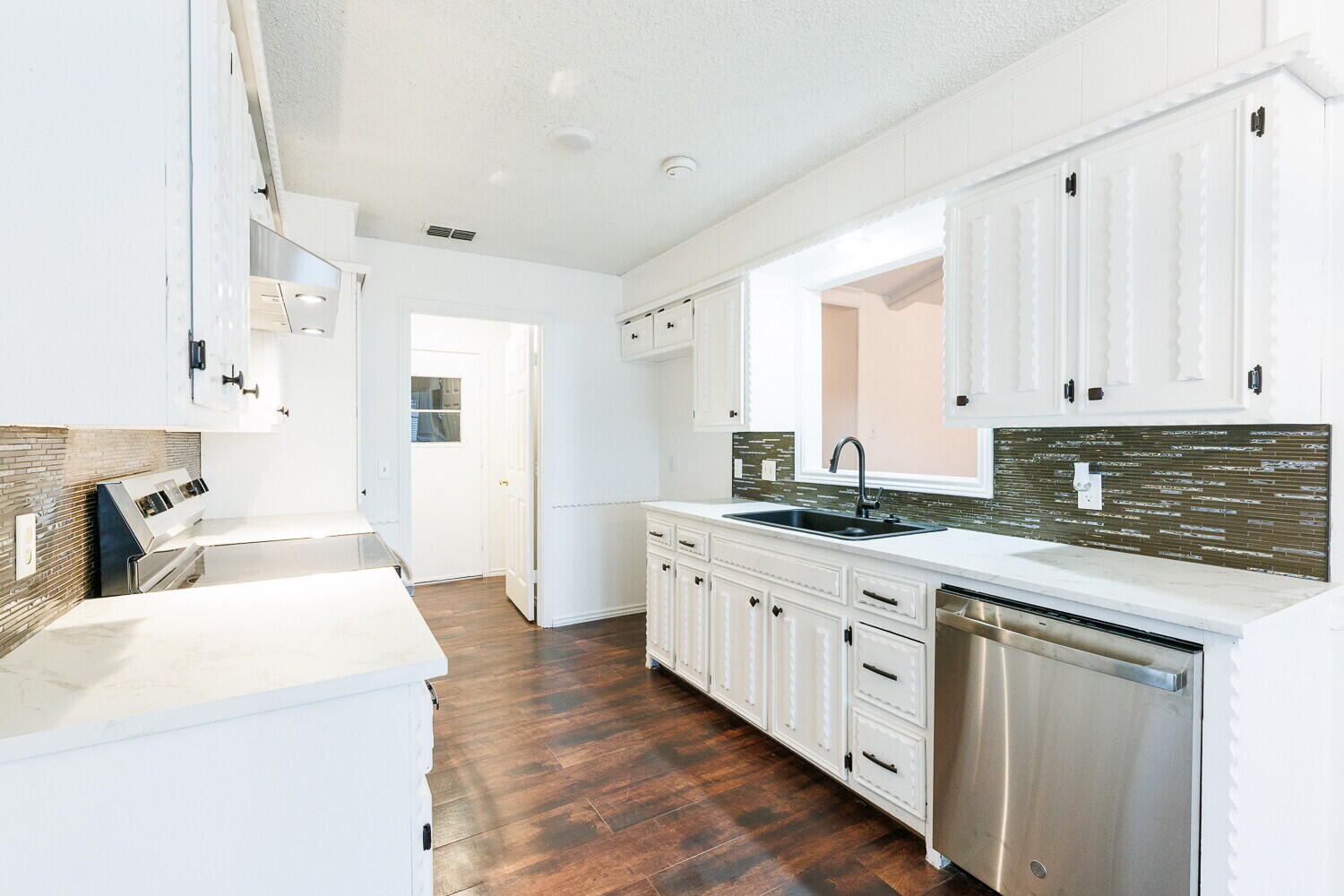 4813 73rd Street Lubbock, TX 79424 - Photo 16 of 49 a kitchen with sink stove and cabinets
