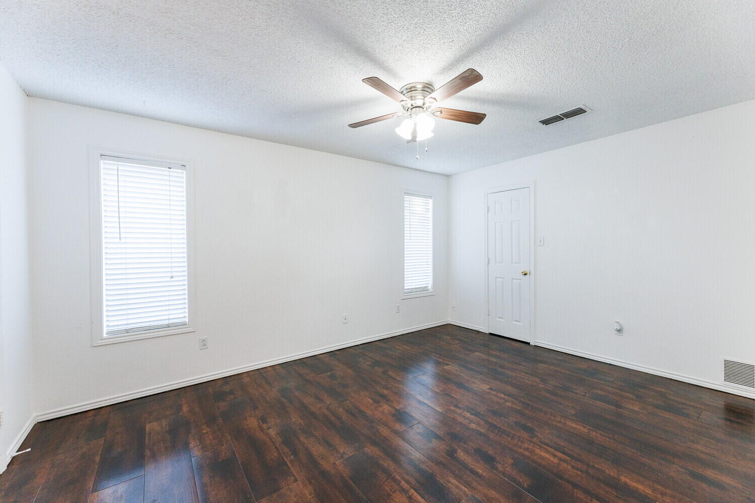 4813 73rd Street Lubbock, TX 79424 - Photo 25 of 49 a view of an empty room with wooden floor and a window