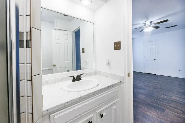a bathroom with a tub a sink and a shower