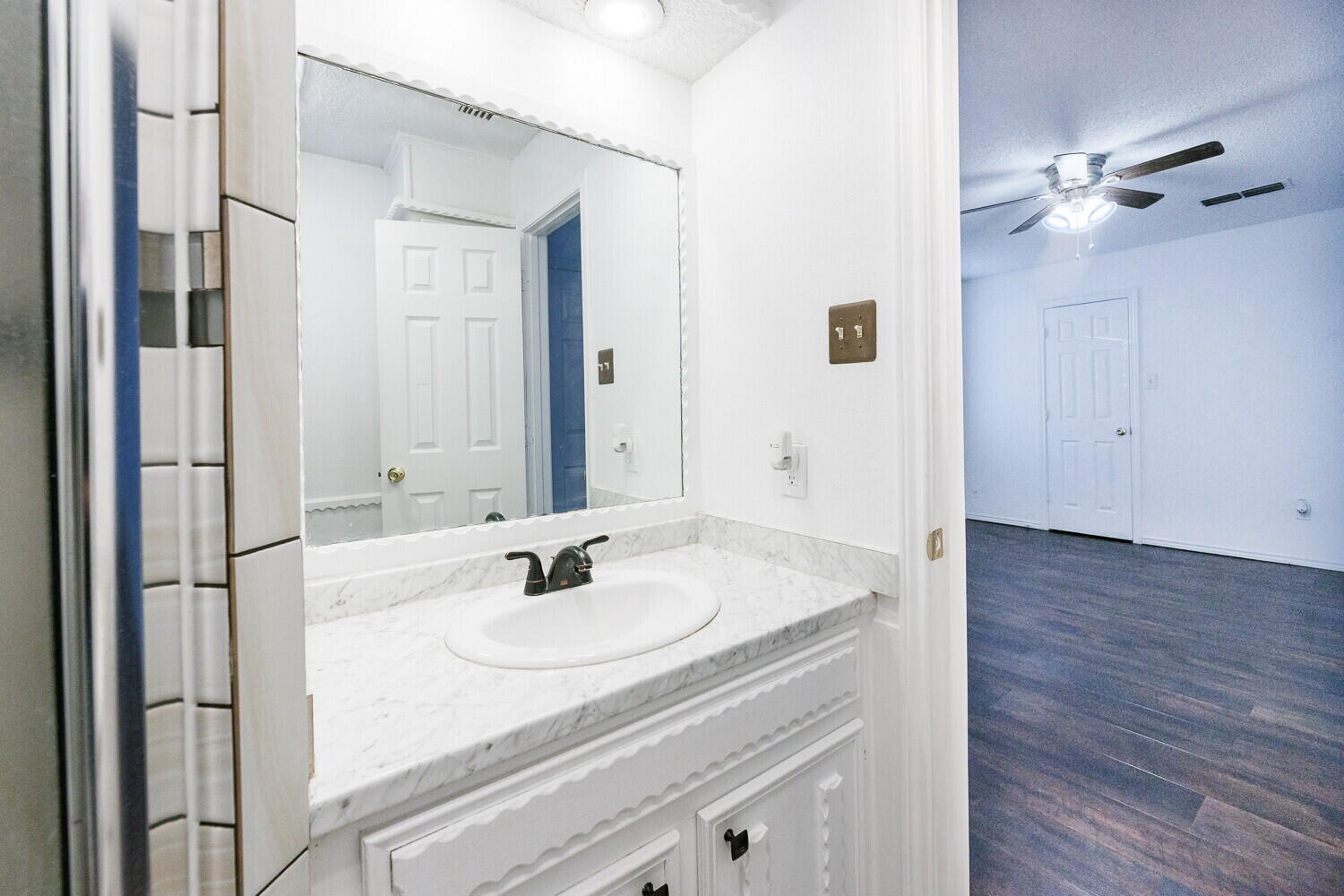4813 73rd Street Lubbock, TX 79424 - Photo 30 of 49 a bathroom with a sink and a mirror