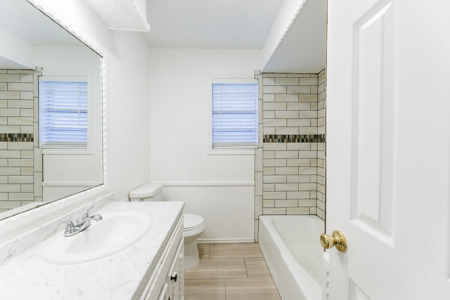 4813 73rd Street Lubbock, TX 79424 - Photo 34 of 49 a bathroom with a tub a sink and a shower