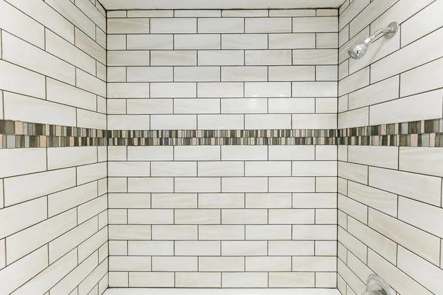 an empty room with wooden floor and a ceiling fan