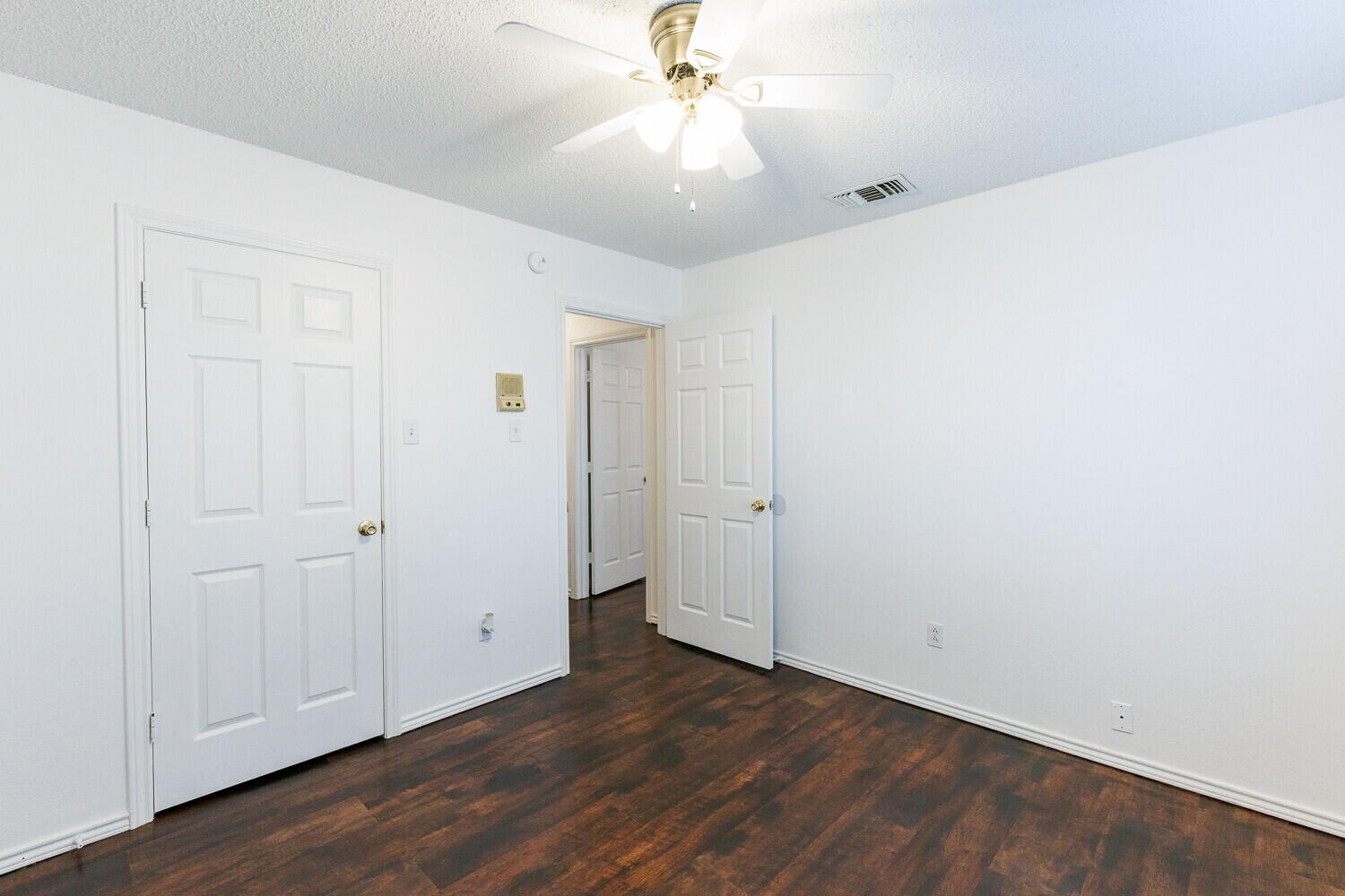 4813 73rd Street Lubbock, TX 79424 - Photo 38 of 49 an empty room with wooden floor and ceiling fan