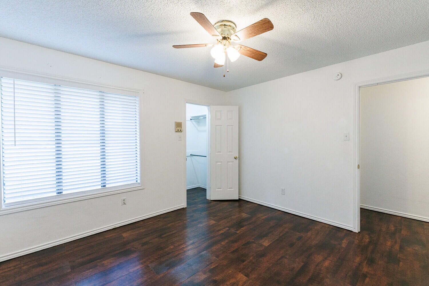 4813 73rd Street Lubbock, TX 79424 - Photo 40 of 49 a view of an empty room with wooden floor and a window