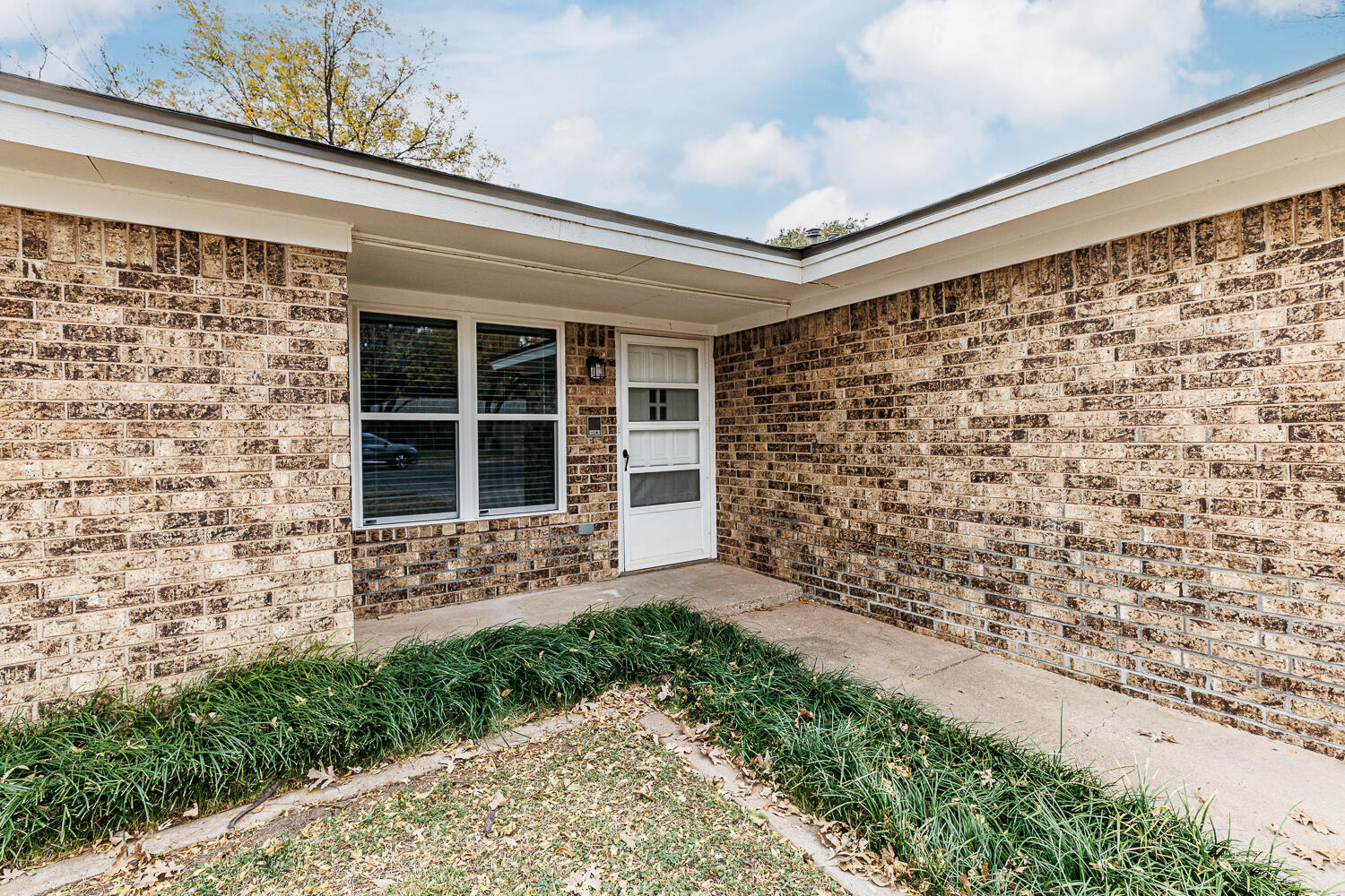 4813 73rd Street Lubbock, TX 79424 - Photo 4 of 49 a front view of a house with a garden