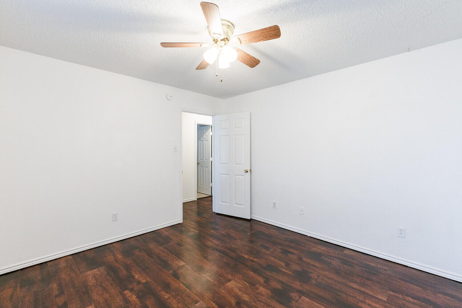 4813 73rd Street Lubbock, TX 79424 - Photo 42 of 49 an empty room with wooden floor and a ceiling fan