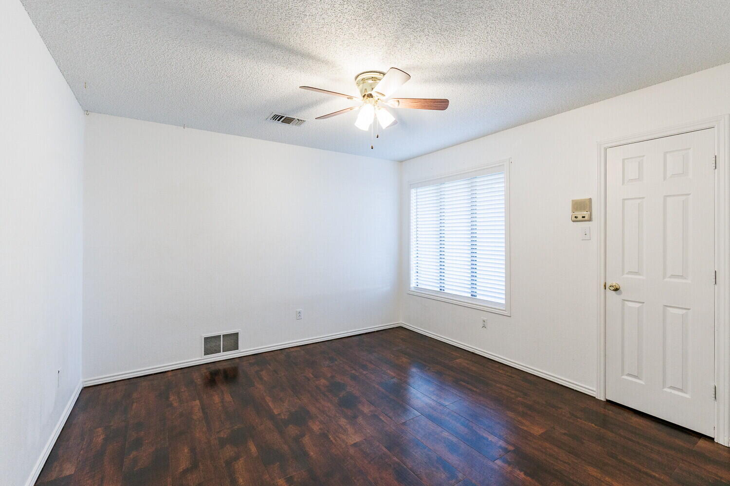 4813 73rd Street Lubbock, TX 79424 - Photo 43 of 49 an empty room with wooden floor fan and windows