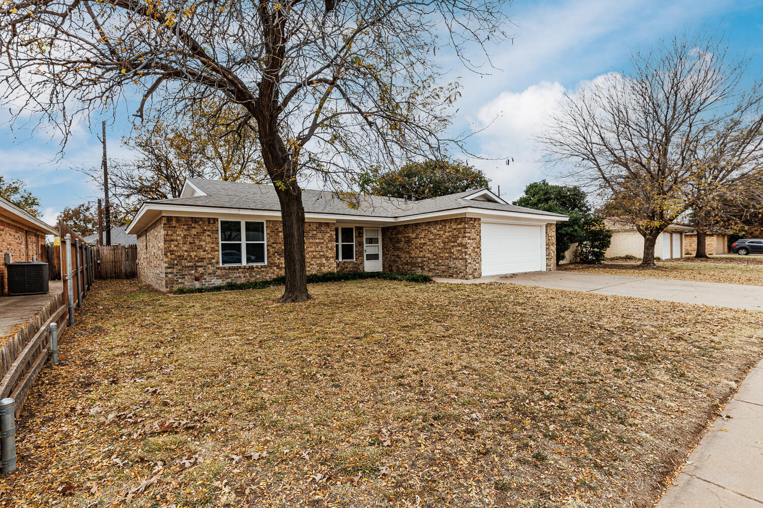 4813 73rd Street Lubbock, TX 79424 - Photo 6 of 49 a front view of a house with a yard