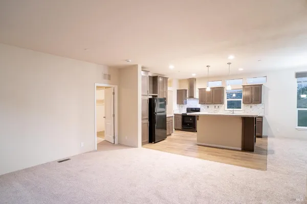 a kitchen with kitchen island a sink stainless steel appliances and cabinets