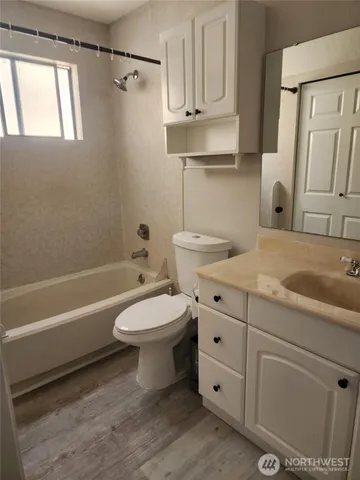 a bathroom with a sink a toilet and bathtub