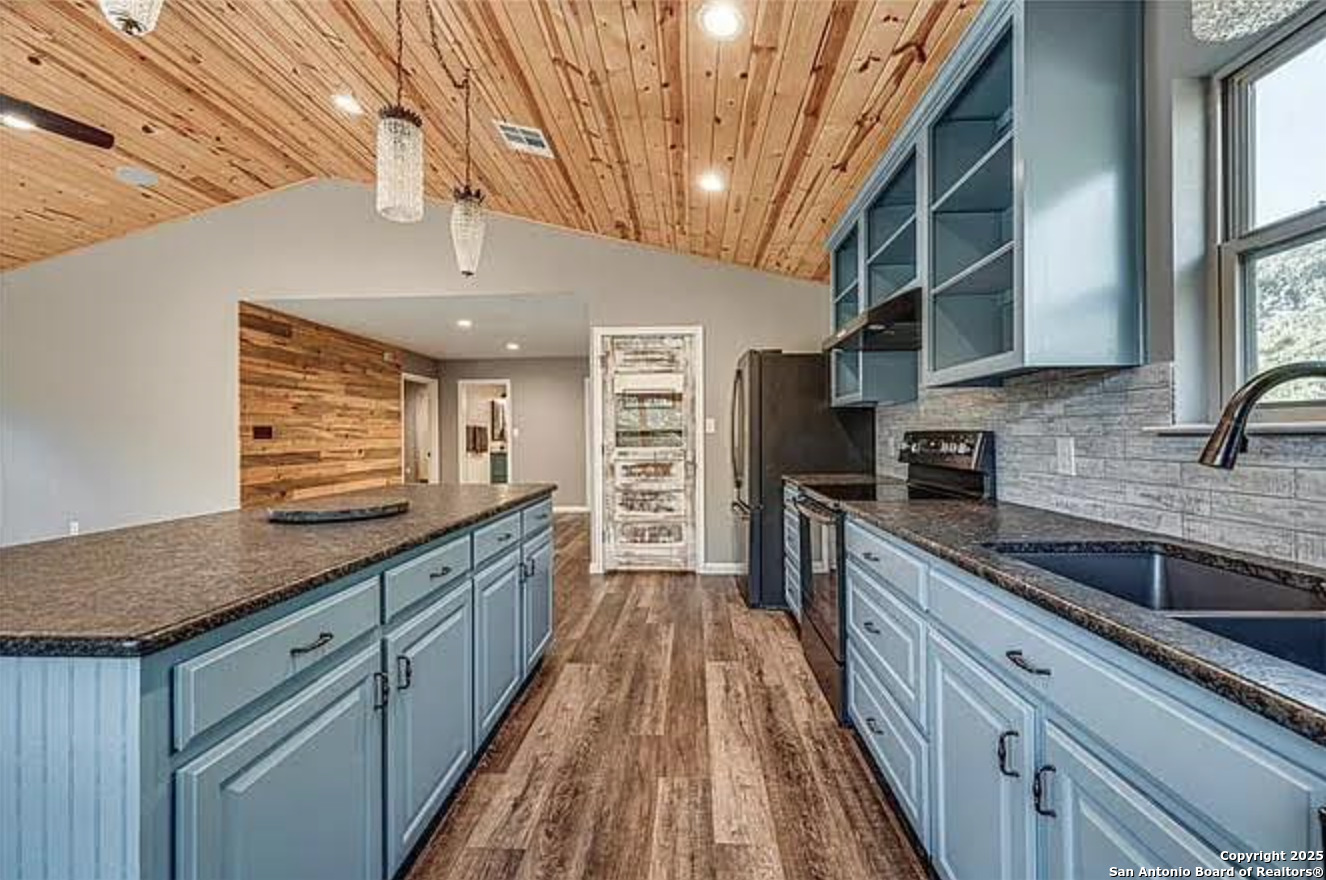 416 Coxs Oak Valley Road Waco, TX 76705 - Photo 5 of 24 a kitchen with stainless steel appliances granite countertop a sink and wooden cabinets