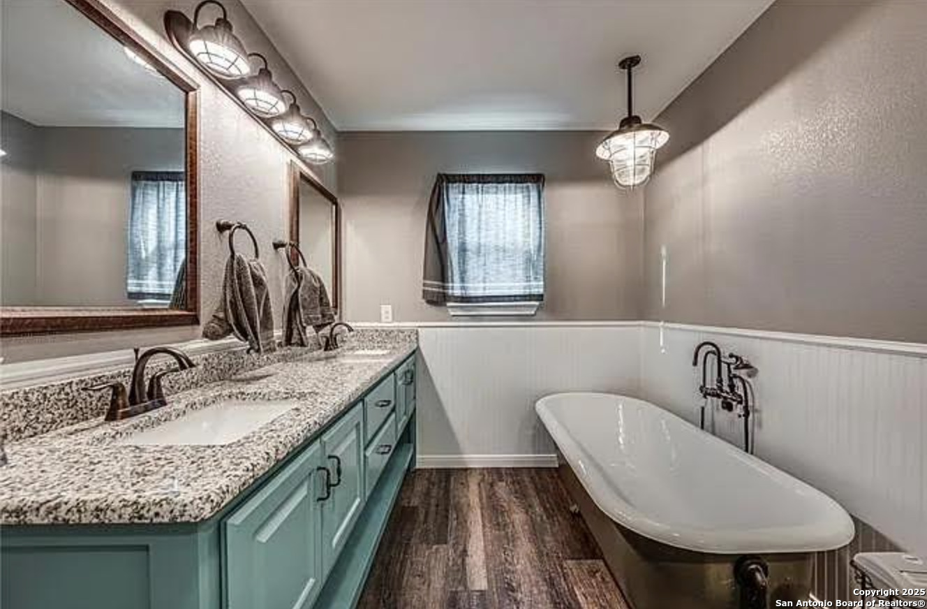 416 Coxs Oak Valley Road Waco, TX 76705 - Photo 9 of 24 a bathroom with a granite countertop sink a mirror and a toilet