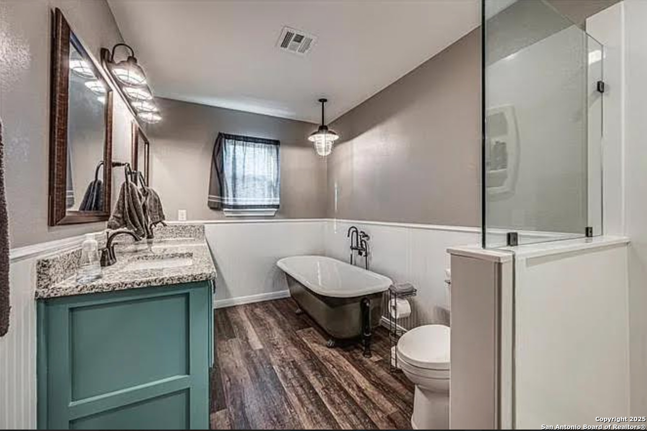 416 Coxs Oak Valley Road Waco, TX 76705 - Photo 10 of 24 a bathroom with a granite countertop toilet sink and mirror