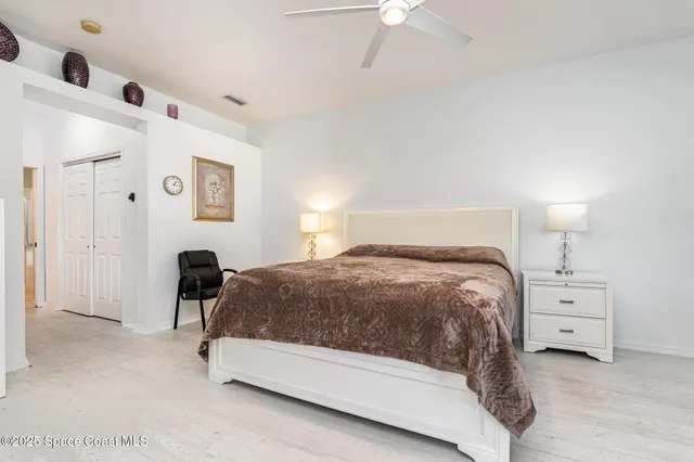 a bedroom with a bed and lamp with window