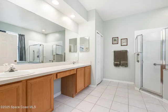 a spacious bathroom with a double vanity sink mirror and