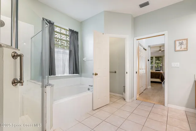 a bathroom with a bathtub and shower