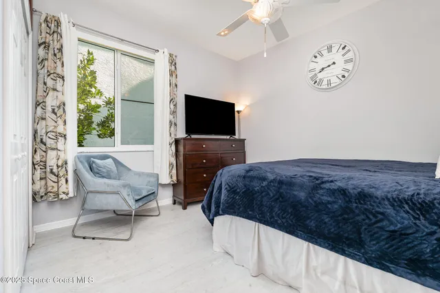a bedroom with a bed and flat screen tv