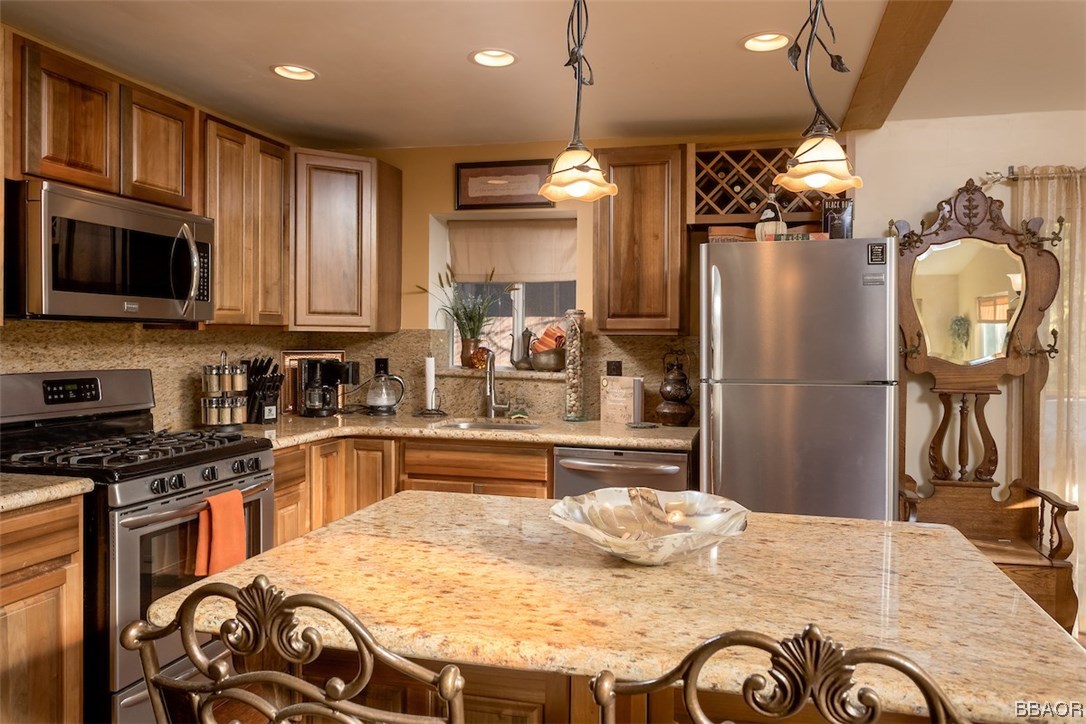 738 Silver Tip Drive Big Bear Lake, CA 92315 - Photo 12 of 30 a kitchen with stainless steel appliances granite countertop a sink refrigerator stove and microwave