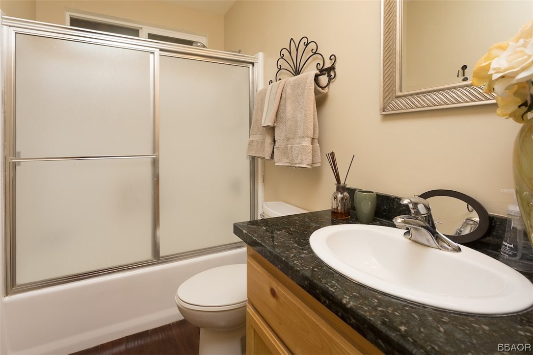 738 Silver Tip Drive Big Bear Lake, CA 92315 - Photo 15 of 30 a bathroom with a granite countertop sink toilet and a mirror