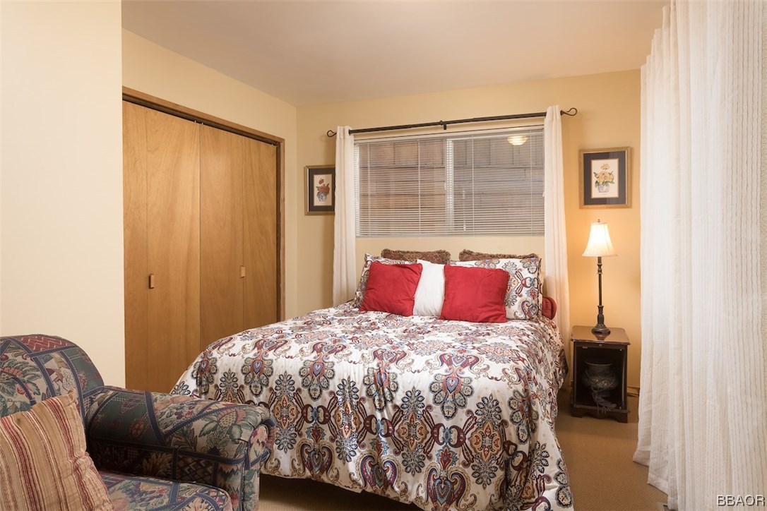 738 Silver Tip Drive Big Bear Lake, CA 92315 - Photo 20 of 30 a bedroom with a large bed and a large window