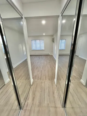 a bathroom with a granite countertop sink a mirror and a bathtub