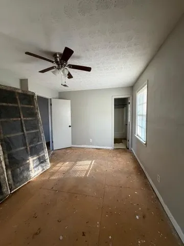 a view of an empty room and kitchen