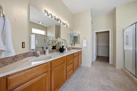 a spacious bathroom with a double vanity sink and a mirror