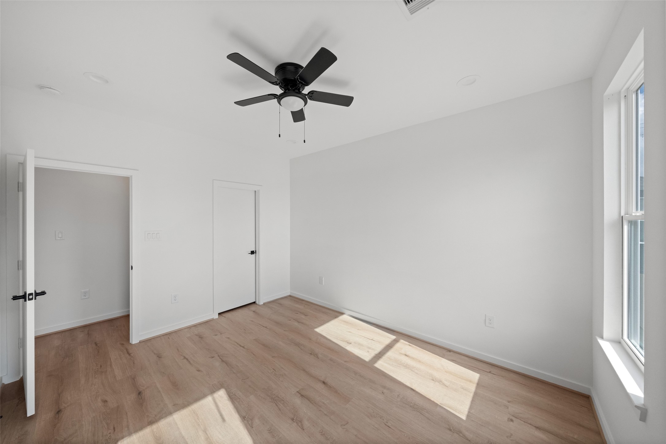 1408 Enid Street Houston, TX 77009 - Photo 22 of 50 wooden floor in an empty room with a window