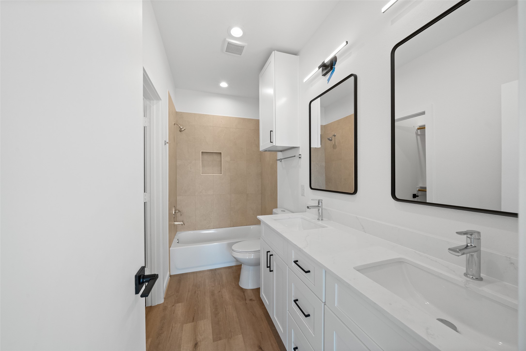 1408 Enid Street Houston, TX 77009 - Photo 23 of 50 a bathroom with a double vanity sink toilet mirror and bathtub
