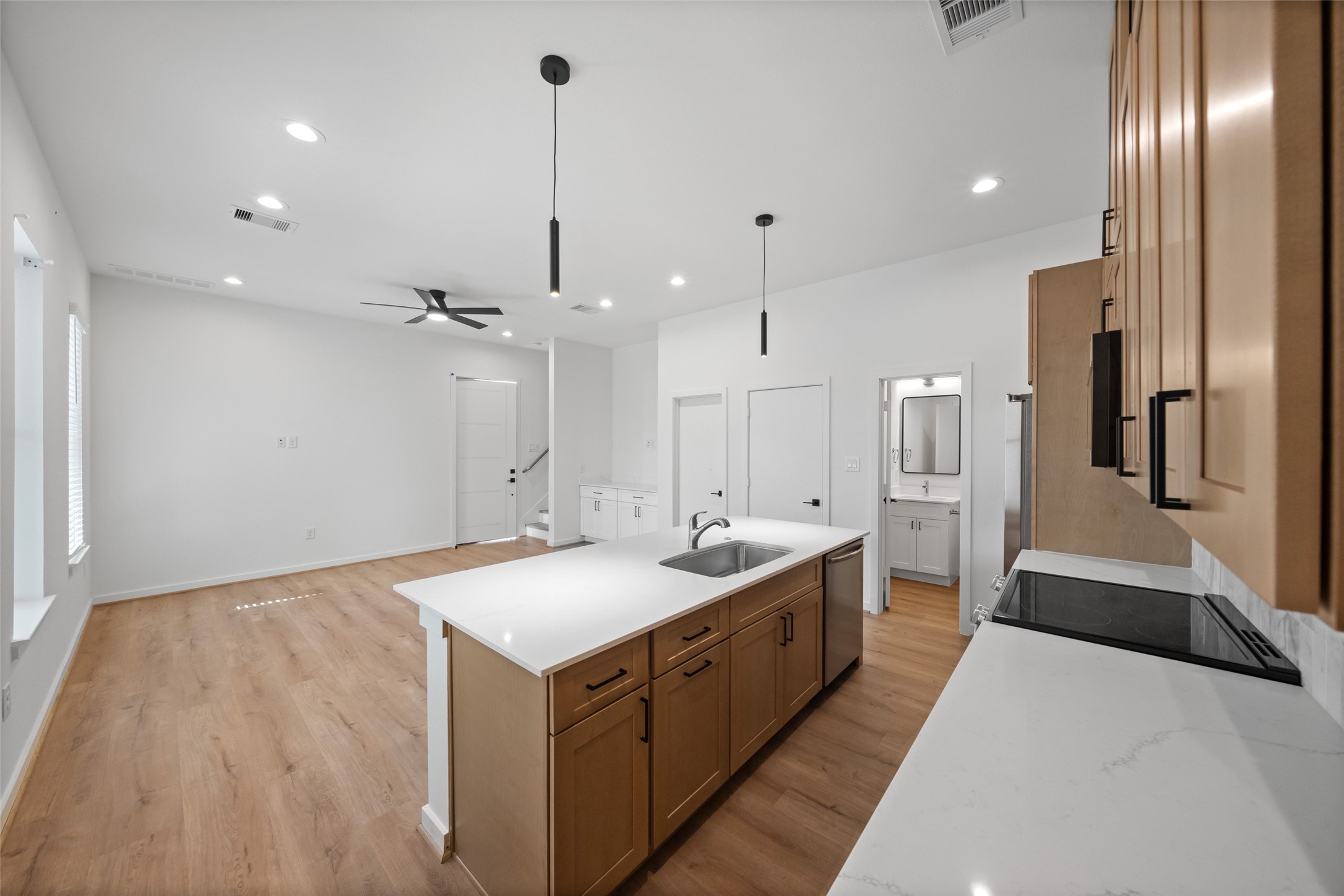 1408 Enid Street Houston, TX 77009 - Photo 28 of 50 a large kitchen with kitchen island a sink stainless steel appliances and a chandelier