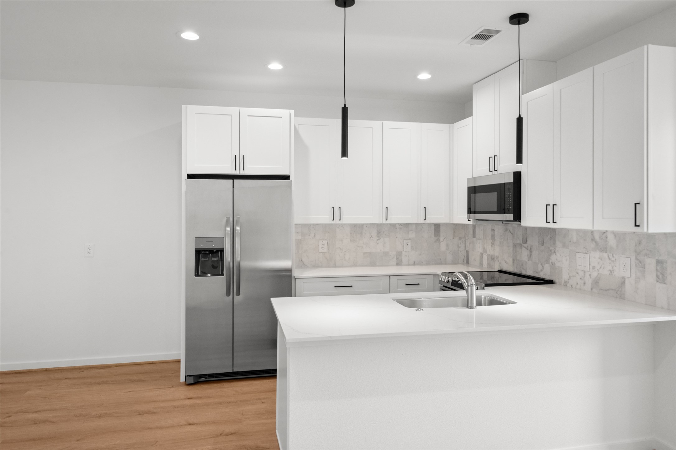 1408 Enid Street Houston, TX 77009 - Photo 43 of 50 a kitchen with stainless steel appliances granite countertop a sink a stove and a refrigerator