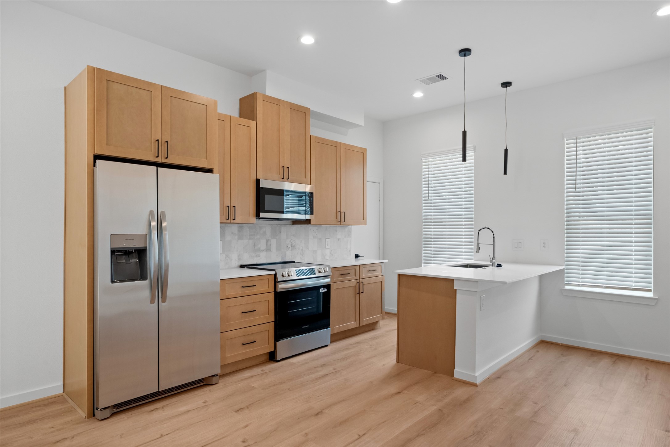 1408 Enid Street Houston, TX 77009 - Photo 8 of 50 a kitchen with stainless steel appliances granite countertop a sink stove and refrigerator