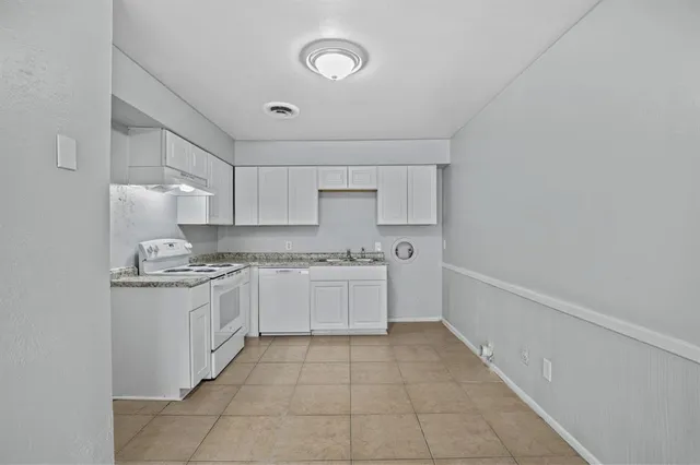 a kitchen with stainless steel appliances granite countertop a sink and cabinets