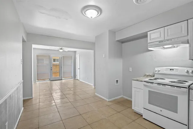 a view of a kitchen with a stove cabinets and a refrigerator